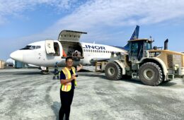 a man standing in front of an airplane