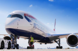 a man standing next to a large airplane