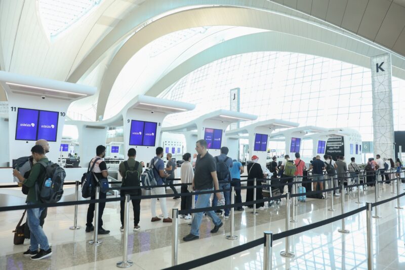 people standing in line at an airport