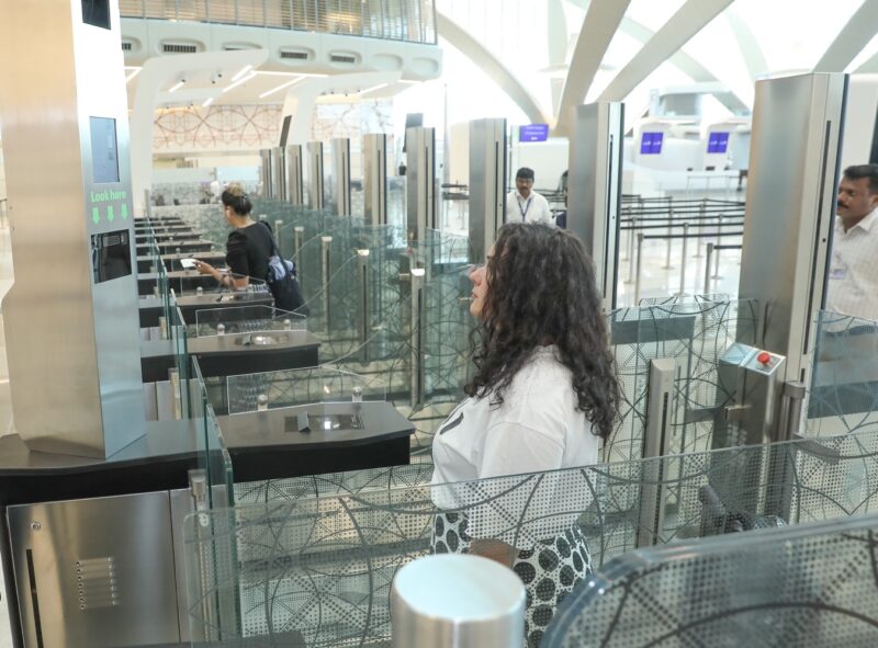 a group of people standing in a row of check-in counters