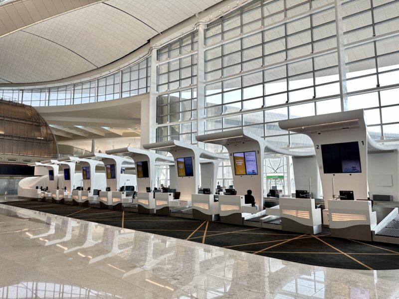 a row of white computers in a large building