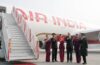 a group of people in uniform standing in front of a plane