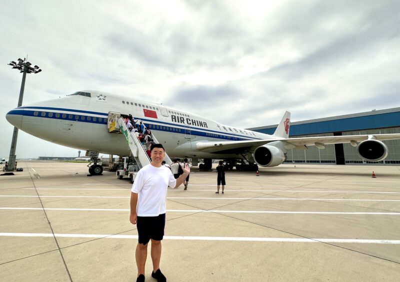 a man standing in front of an airplane