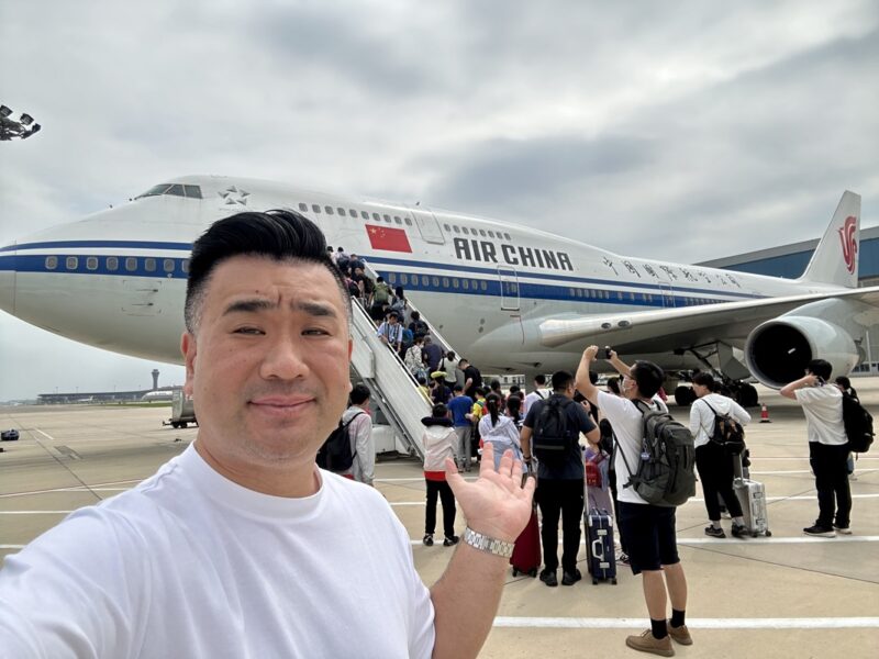 a man taking a selfie with a plane