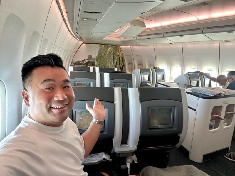 a man waving in an airplane