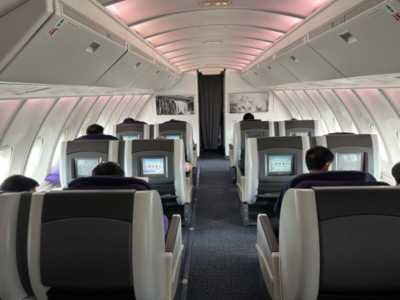 a group of people sitting in an airplane