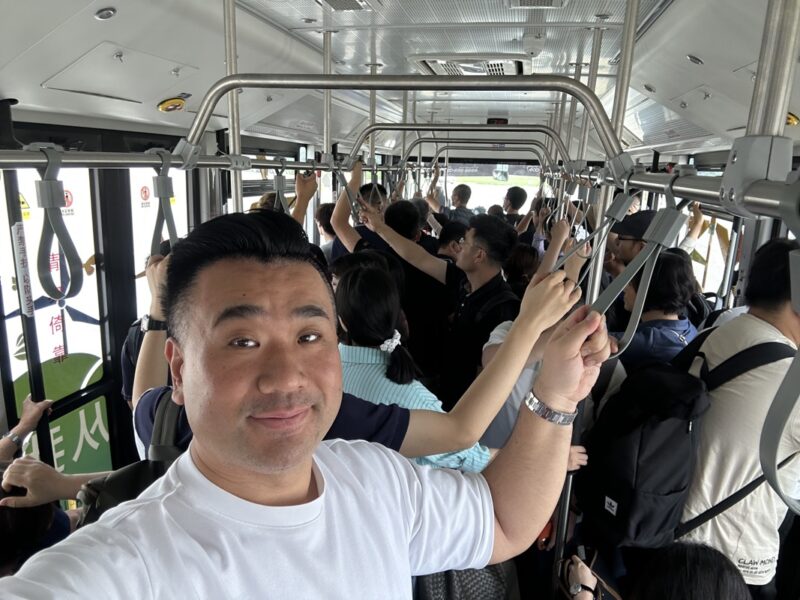 a man taking a selfie on a bus