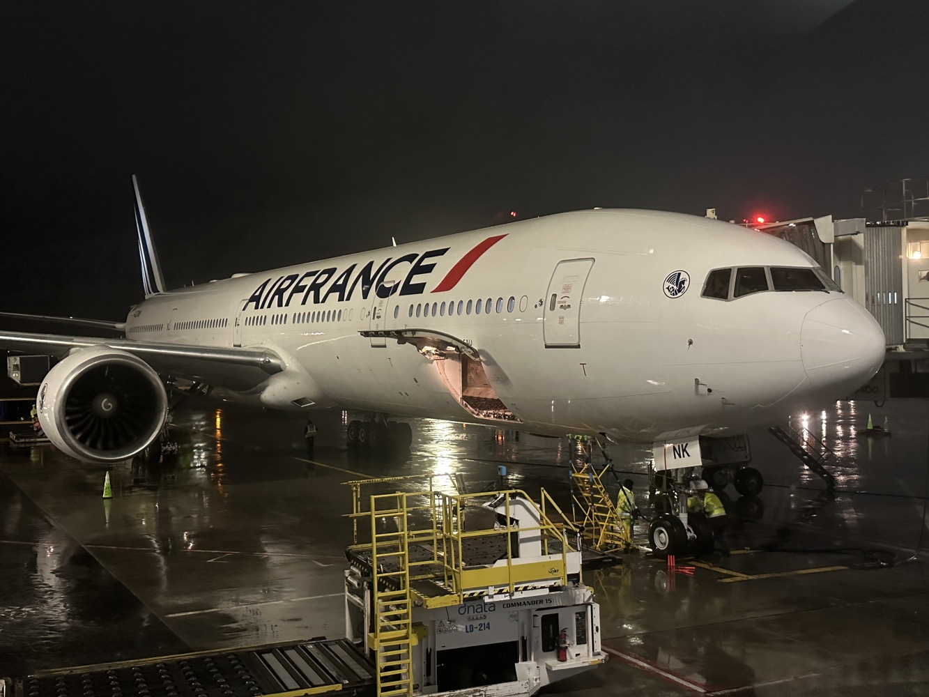 a large white airplane on a wet runway