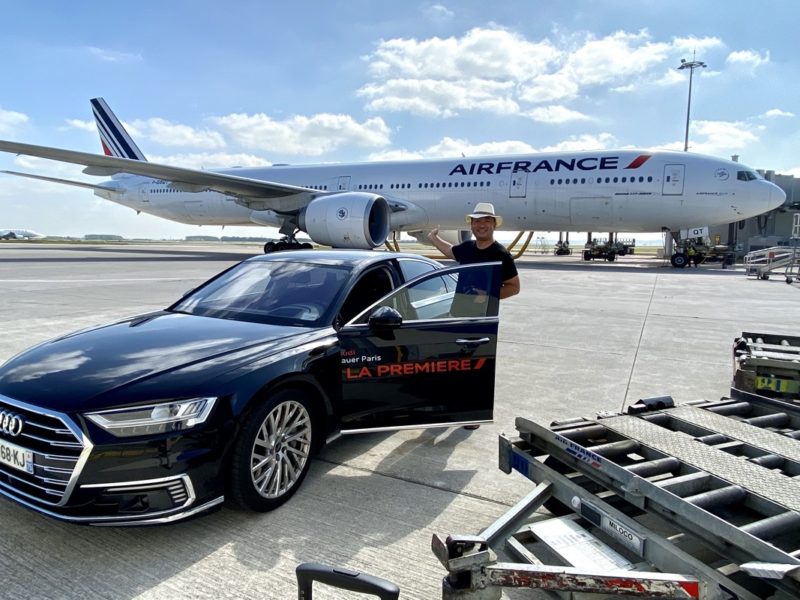 a man standing next to a car