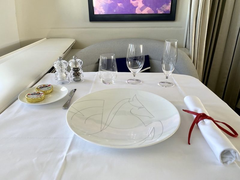 a table with a plate and glasses on it