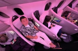 a group of people sitting in chairs on an airplane