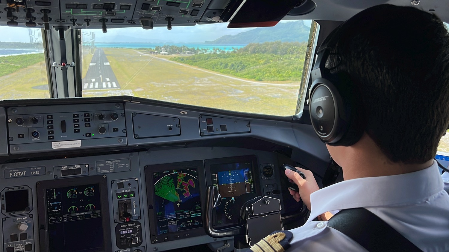 a person in a pilot's uniform in a cockpit