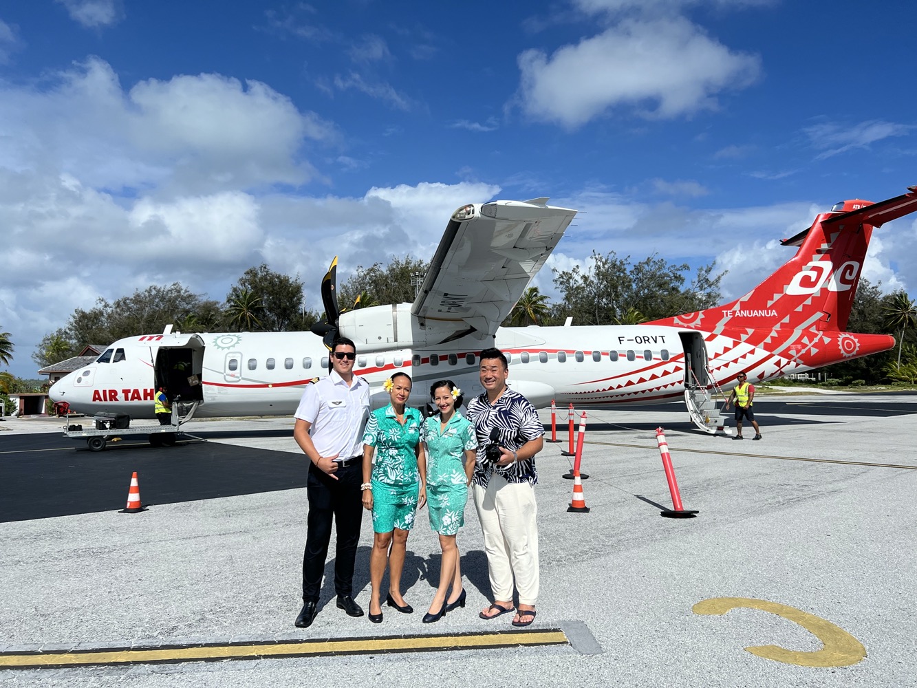 a group of people standing in front of an airplane