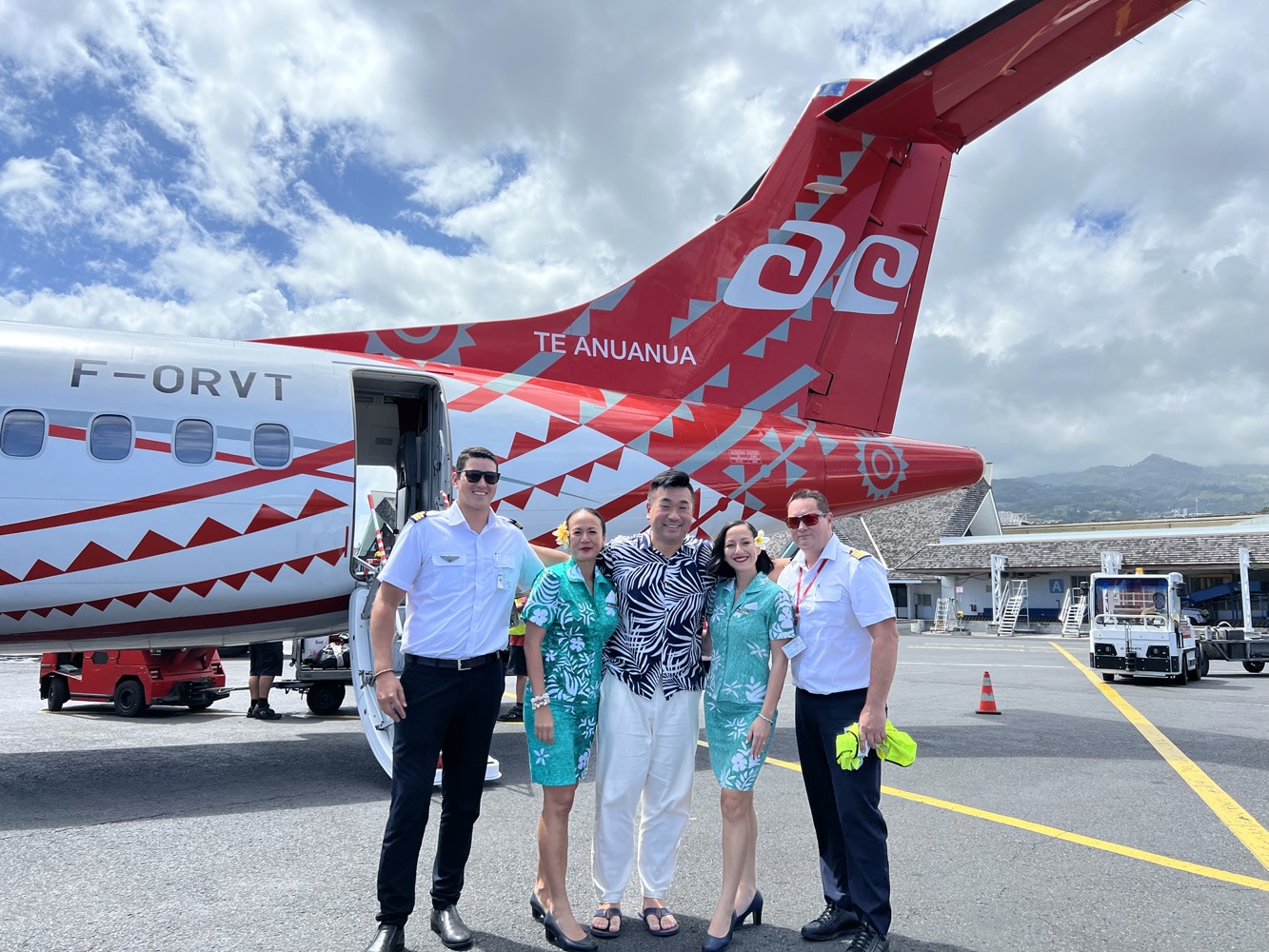 a group of people standing in front of a plane