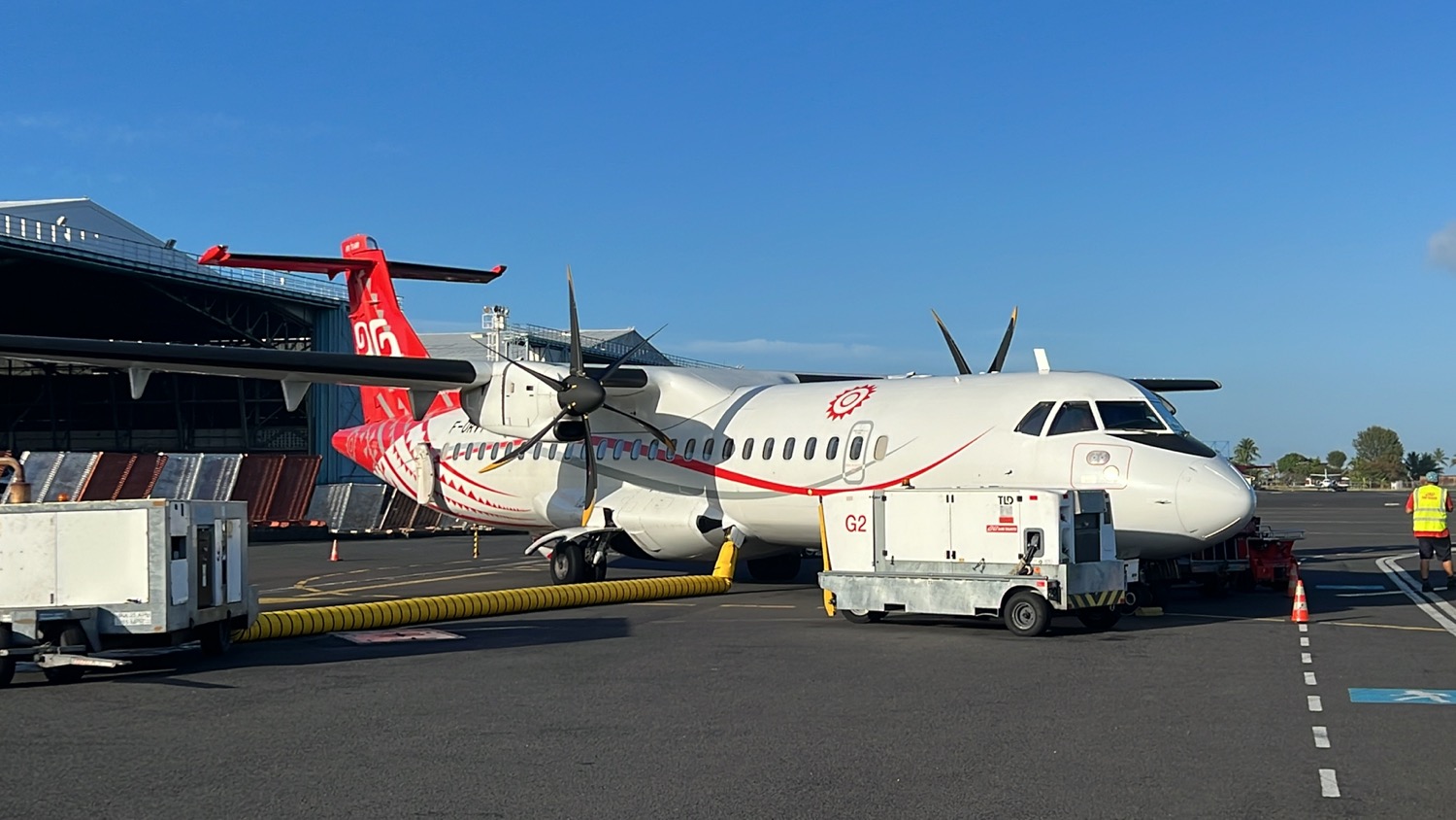 a white airplane with red and white design on the side