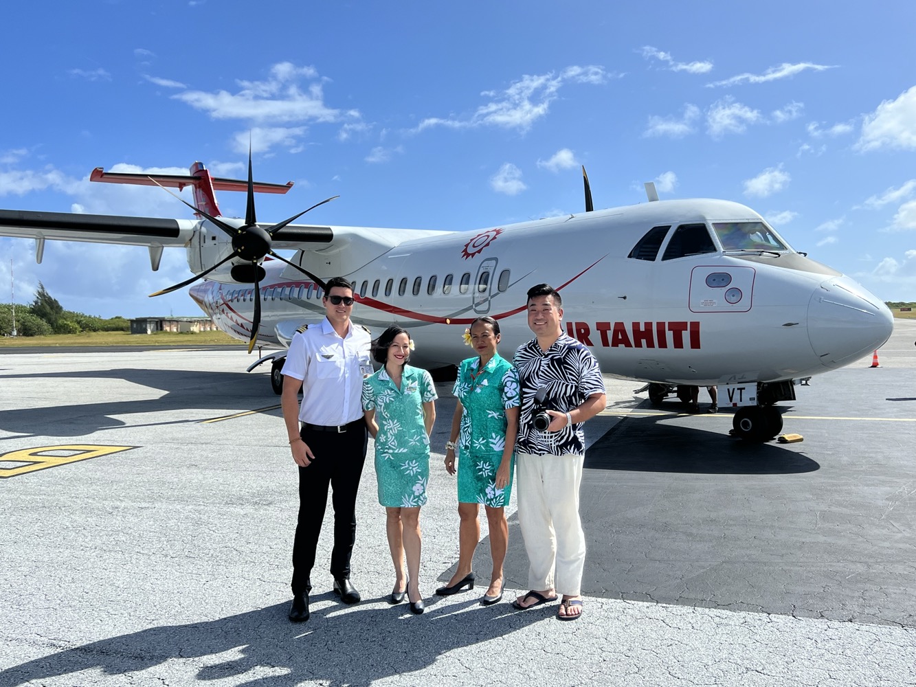 a group of people standing in front of a plane