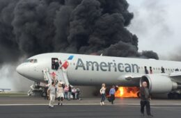 a plane with people walking on the ground