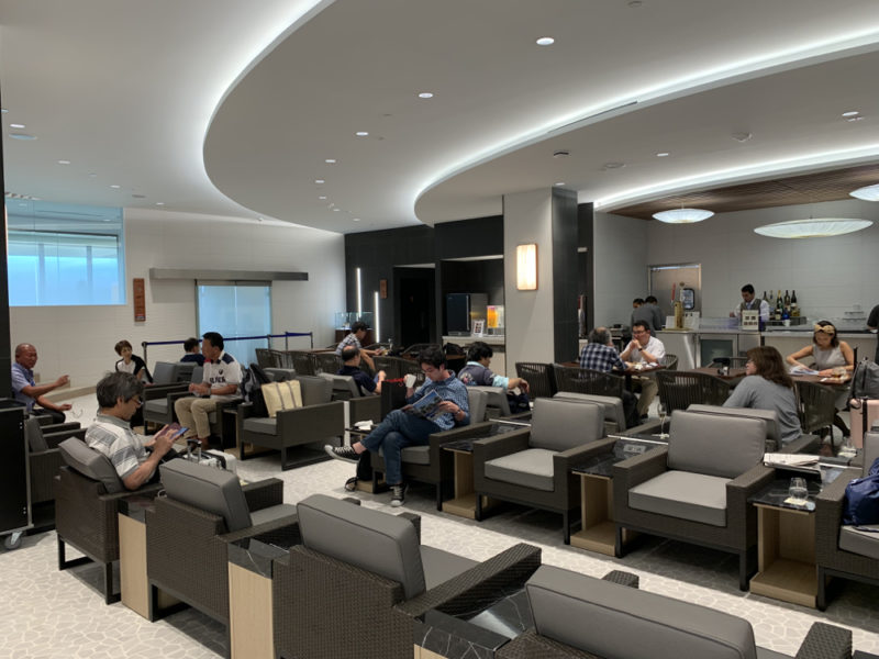 a group of people sitting in a room with chairs