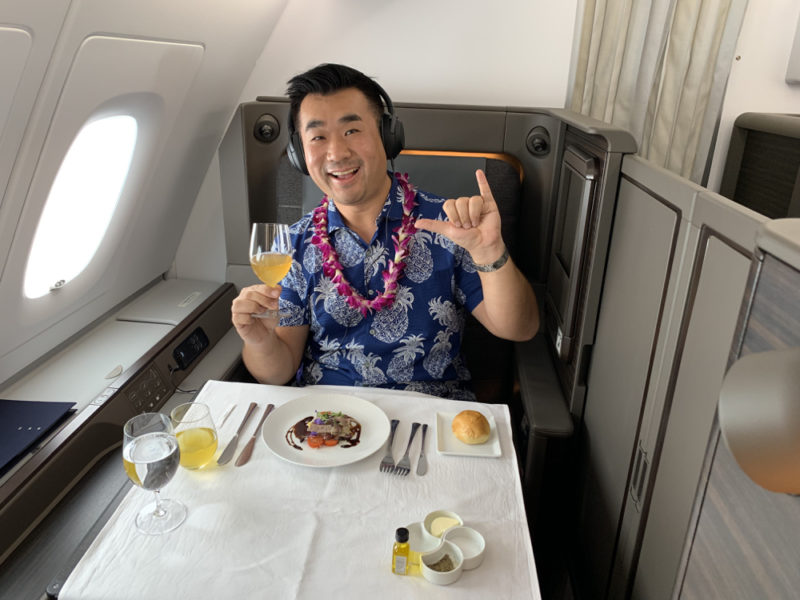 a man sitting at a table with food and drink