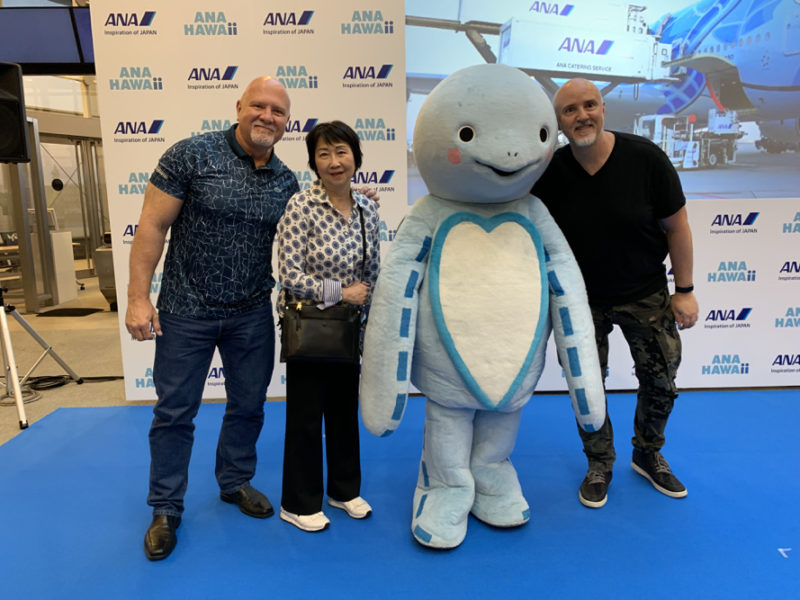 a group of people posing with a mascot