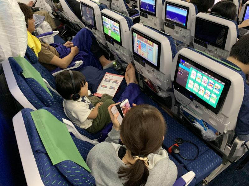 a group of people sitting in chairs with computers