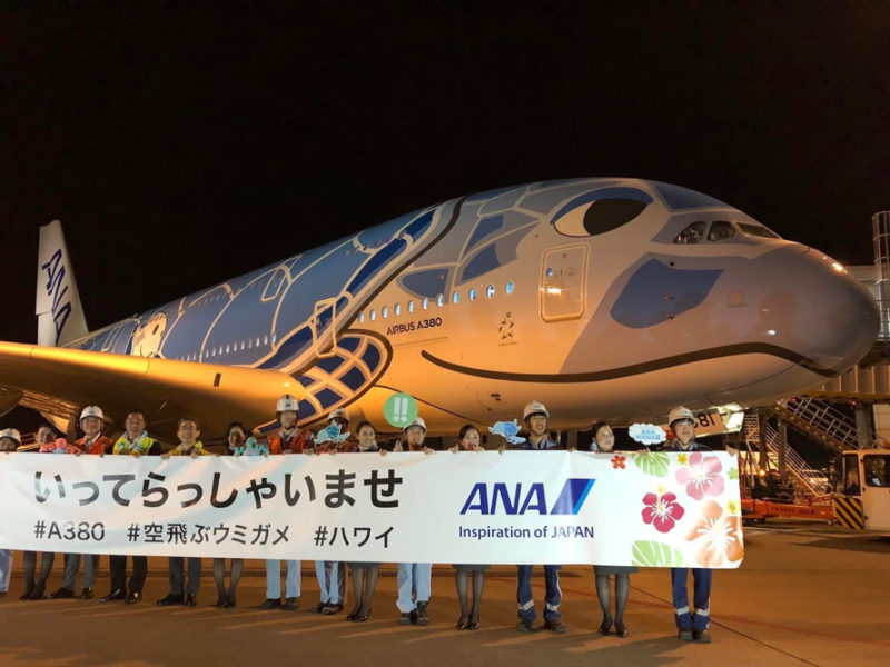 a group of people standing in front of a large airplane