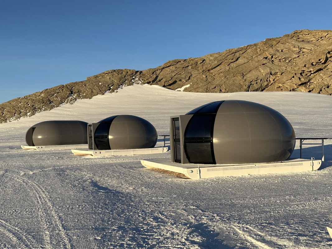 a group of round buildings in the snow