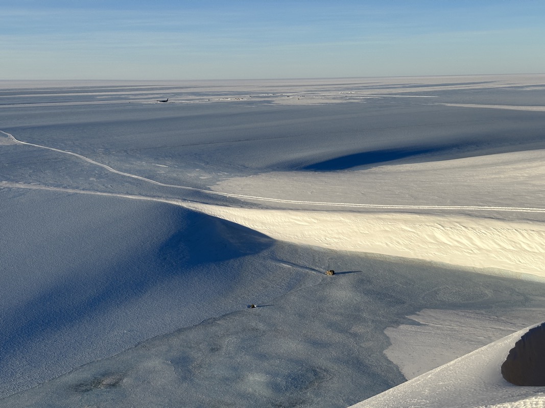 a snow covered ground with a path in the middle