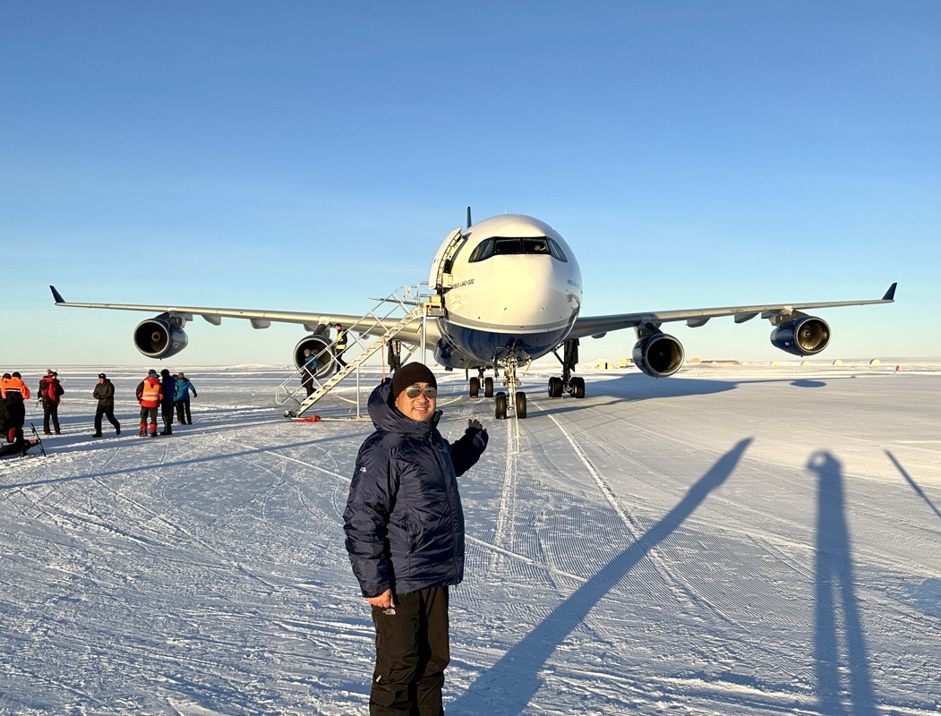 a man standing in front of an airplane