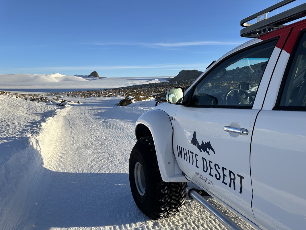 a white truck parked in the snow