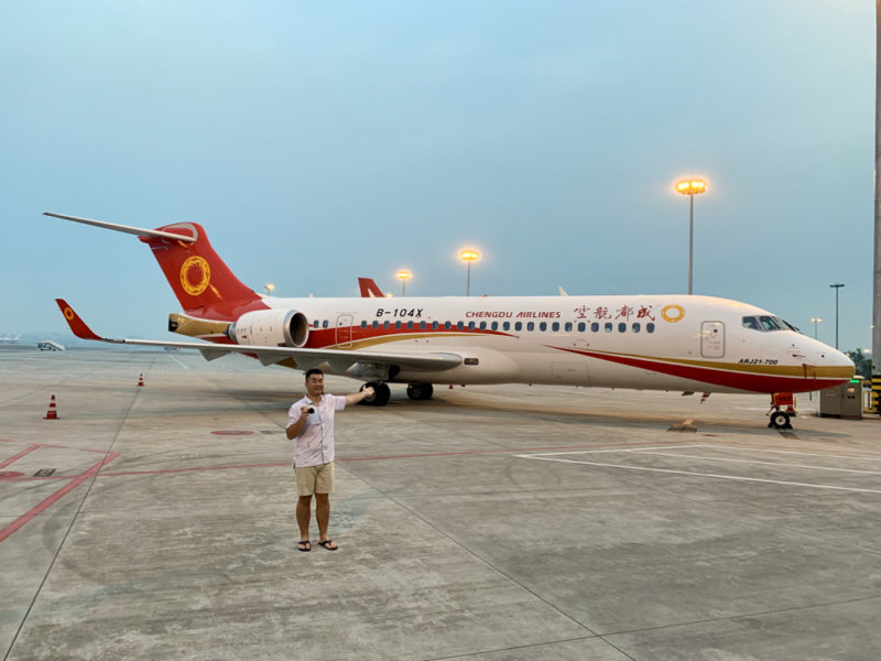 a man taking a picture of a plane