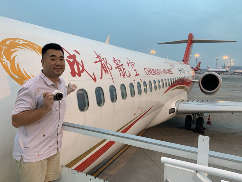 a man standing in front of an airplane