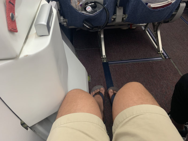 a person's legs on a plane