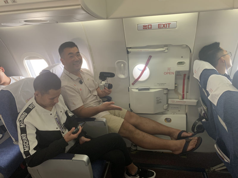 a group of men sitting in an airplane