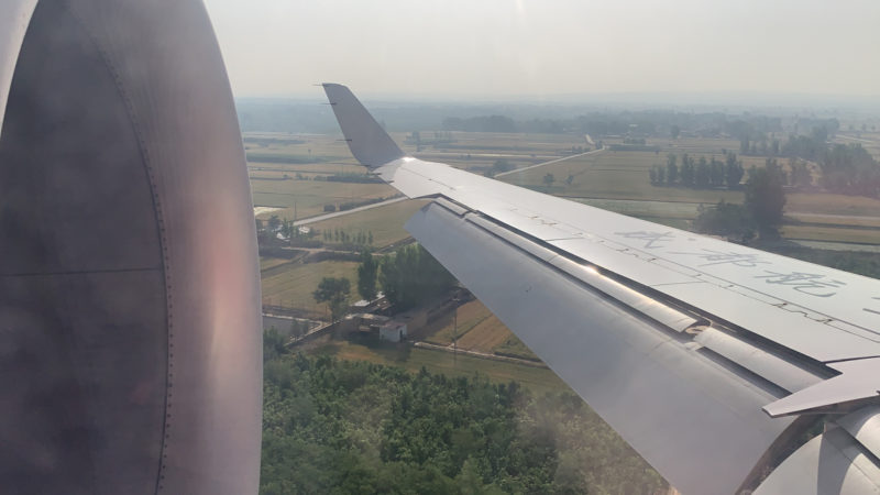 an airplane wing and a landscape