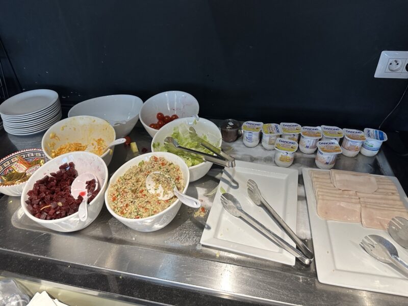 a buffet table with bowls of food and other dishes