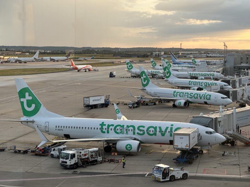 a group of airplanes parked on a runway