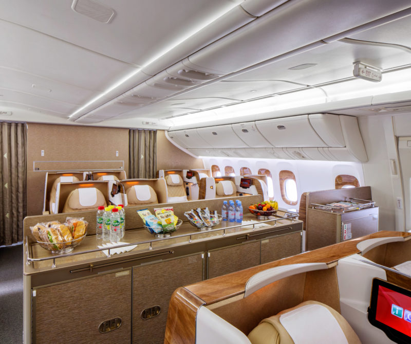 a food and drinks on a table in an airplane