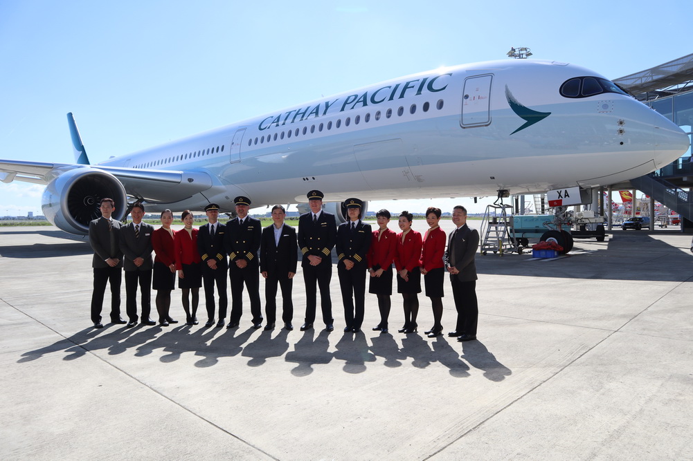 a group of people standing in front of a plane