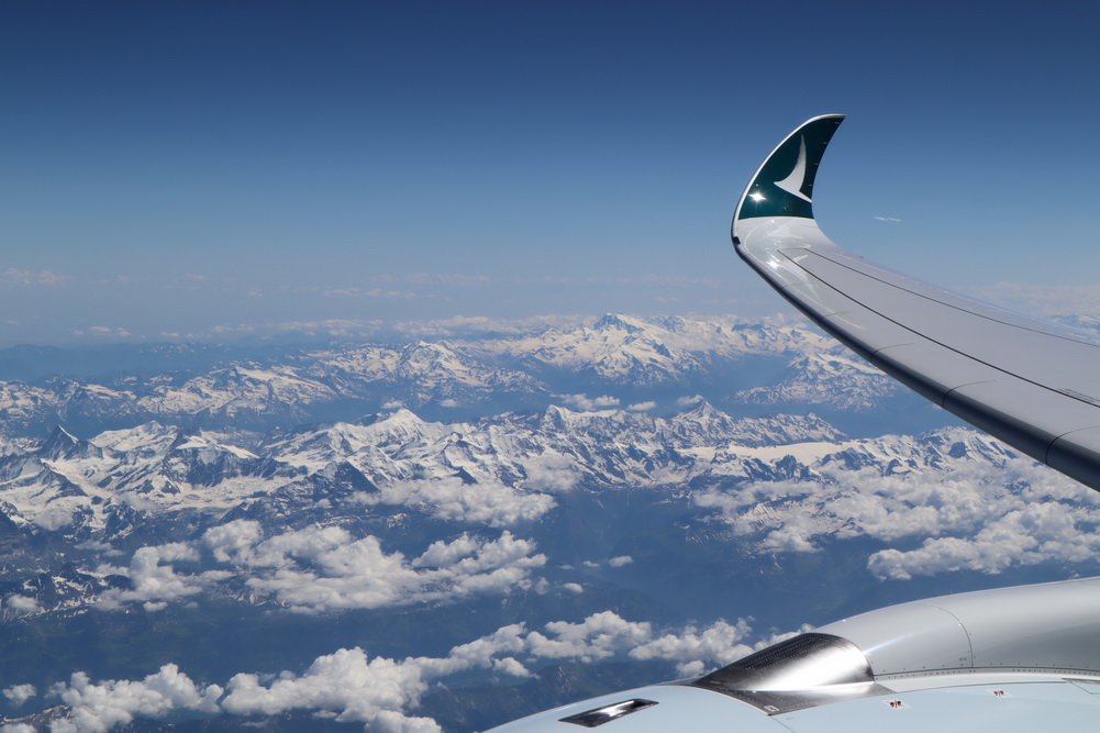 a wing of an airplane above the clouds