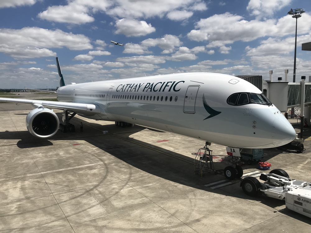 a large white airplane on a concrete surface