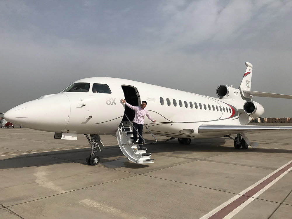 a person standing on a staircase of a plane