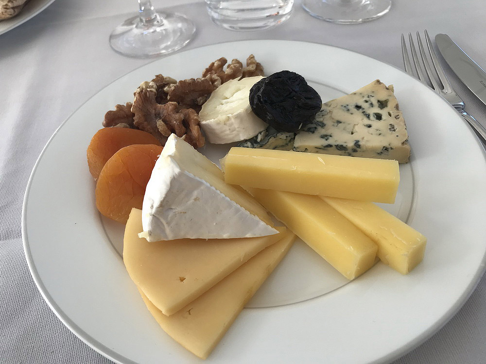 a plate of cheese and nuts