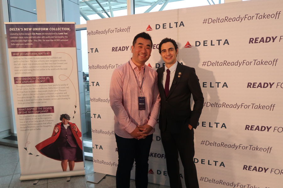 two men standing in front of a sign