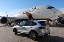 a car parked next to a large airplane