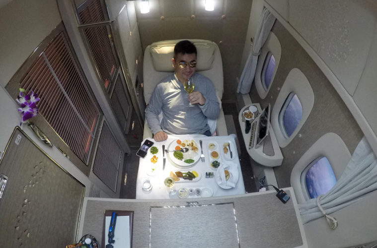 a man sitting in a chair with a glass of wine