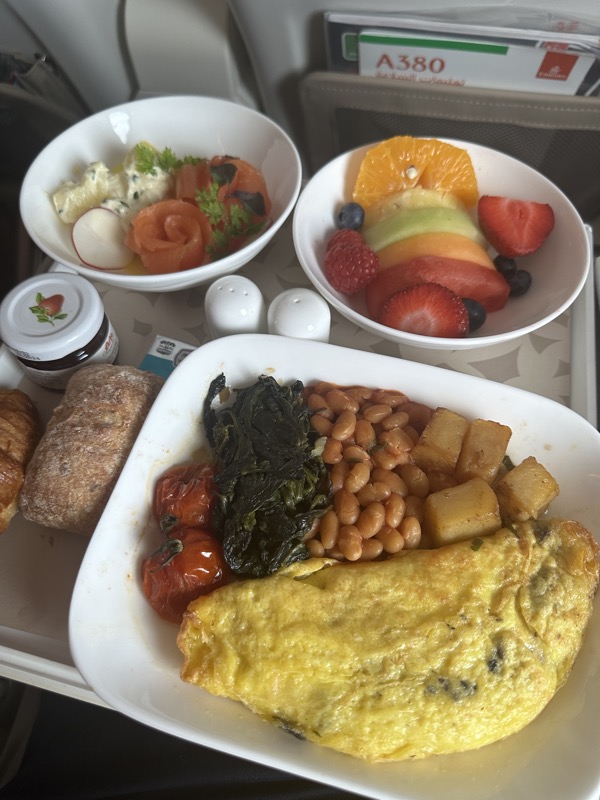 a plate of food and fruit on a tray