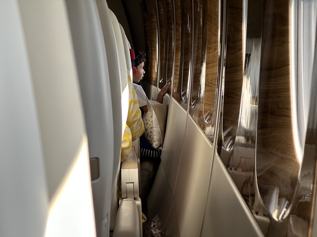 a boy sitting on a plane