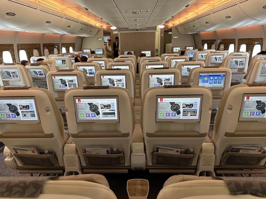 a row of seats with monitors on the back