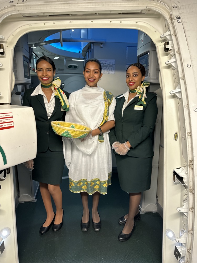 a group of women in uniform standing in a plane